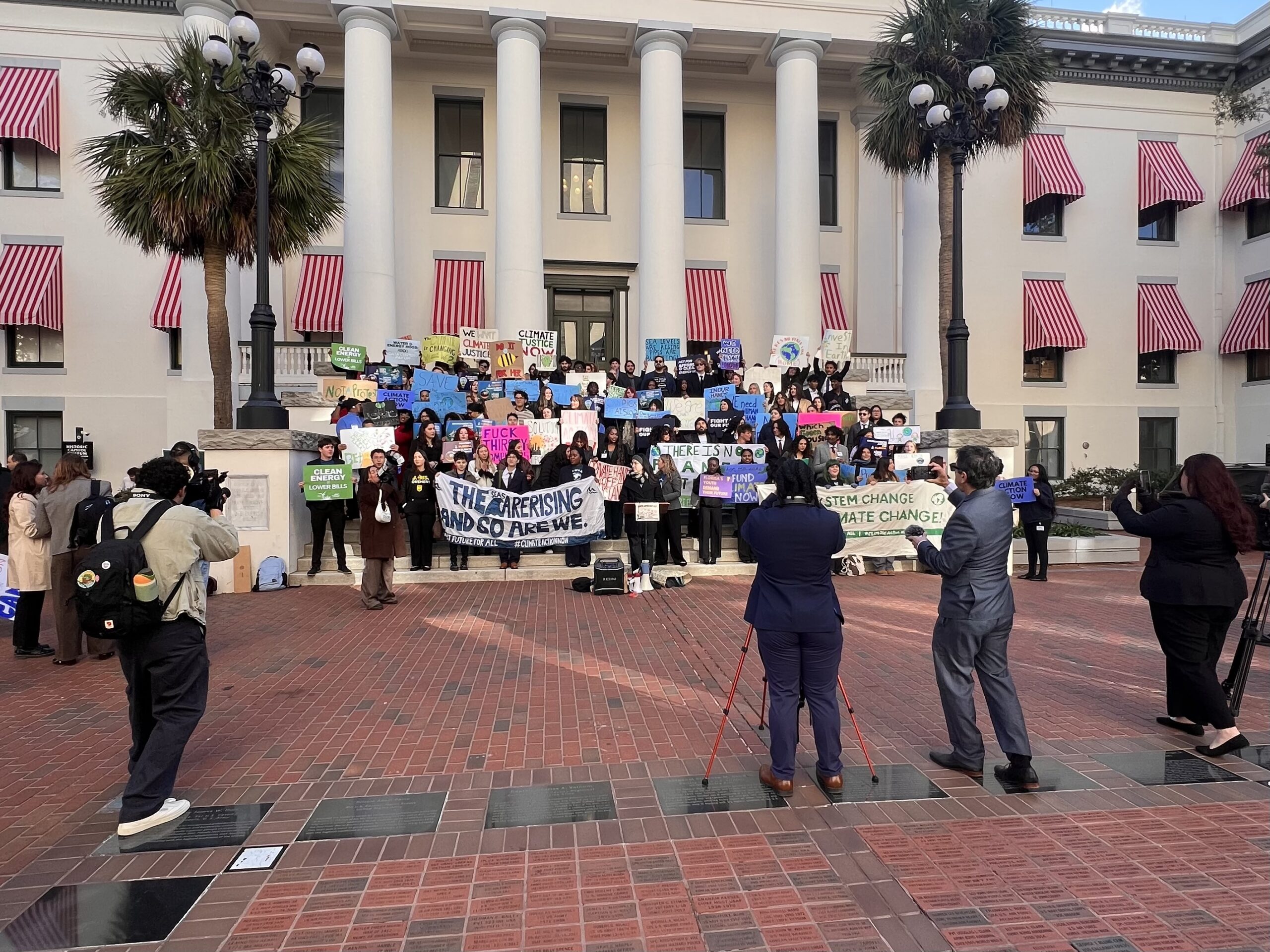 Protestors rally against climate change at the Florida Capitol.