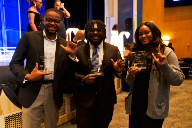 Khalil-Lullah B., Elijah L., and Hannah K. smiling with awards, pictured right to left. (Alicia Adams/WANM)